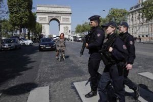 Armed French police patrol the Champs Elysees Avenue the day after a policeman was killed and two others were wounded in a shooting incident in Paris