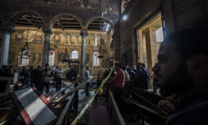 Egyptian security forces inspect the scene of a bomb explosion at the Saint Peter and Saint Paul Coptic Orthodox Church in Cairo on December 11, 2016. AFP/KHALED DESOUKI