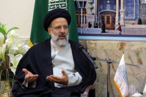 Iranian senior cleric Ebrahim Raisi gestures as he meets grand clerics in the holy city of Qom