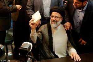 Iranian cleric Ebrahim Raisi gestures after registering his candidacy for the upcoming presidential elections at the ministry of the interior in Tehran on April 14, 2017