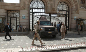 Yemeni soldiers stand guard outside the cabinet headquarters during the weekly parliament session with Yemeni ministers.