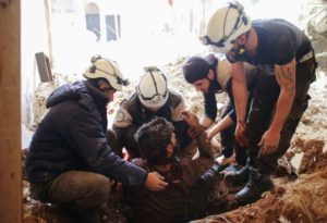 Members of the Syrian Civil Defence, also known as the White Helmets, remove a victim from the rubble of his house on April 8 in the southern Syrian city of Daraa.