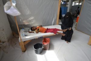 Woman sits next to her son who is infected with cholera at a hospital in the Red Sea port city of Hodeidah, Yemen