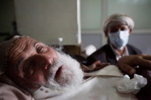 An old man infected with cholera lies on the bed at a hospital in Sanaa