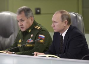 Russian President Putin with Defence Minister Shoigu attend meeting on Russian air force's activity in Syria at national defence control centre in Moscow