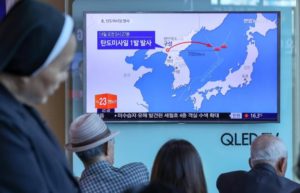 People watch a news report on North Korea firing a ballistic missile, at a railway station in Seoul