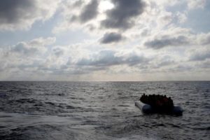 Migrants in a dinghy await rescue by the Migrant Offshore Aid Station around 20 nautical miles off the coast of Libya