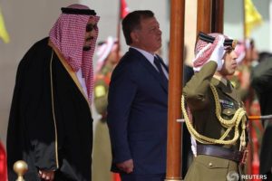 Jordan's King Abdullah II and Saudi Arabia's King Salman bin Abdulaziz Al Saud review honour guards at the airport in Amman