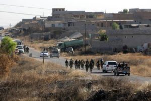 Kurdish Peshmerga forces gather in a village east of Mosul, Iraq