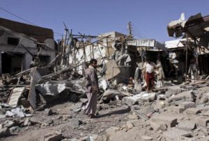 People inspect the site of an air strike in Yemen's northwestern city of Saada