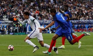 England’s Dele Alli is fouled by France’s Raphaël Varane early in the second half. After the referee consulted his video assistant, Varane was sent off.