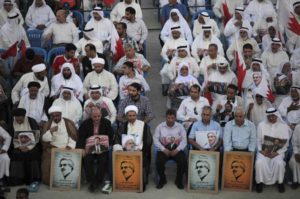 Leaders of opposition groups, including Sheik Ali Salman, head of the largest Shiite Muslim opposition society Al Wefaq, front row fourth left, participates with thousands of Bahrainis carrying national flags and posters of jailed political and religious opposition figures in a rally in Muqsha, Bahrain. A court in Bahrain has the ordered the country's last functioning opposition group dissolved and its property confiscated.