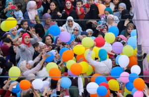 Egyptians celebrate and try to catch balloons released after Eid