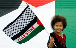 Zeina, a 6-year-old Belgian-Palestinian girl, waves a Palestinian flag during a protest in central Brussels.