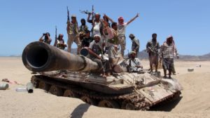 Anti-Houthi fighters of the Southern Popular Resistance stand on a tank in Yemen’s southern port city of Aden on May 10, 2015.