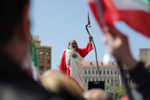 A man dressed up in a Lebanese flag attends a demonstration against proposed tax increase, in Beirut.