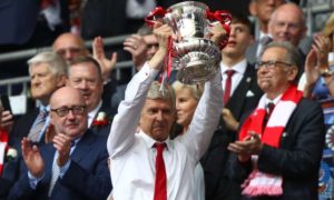 Arsène Wenger, the Arsenal manager, shows his pride when lifting the FA Cup trophy at Wembley. Photograph: Ian Walton/Getty Images