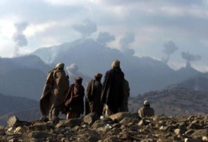 AFGHAN FIGHTERS WATCH SEVERAL EXPLOSIONS FROM US BOMBINGS IN THE TORA BORA MOUNTAINS.