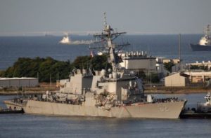 The Arleigh Burke-class guided-missile destroyer USS Fitzgerald, damaged by colliding with a Philippine-flagged merchant vessel, is towed by a tugboat upon its arrival at the U.S. naval base in Yokosuka