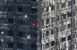 Members of the emergency services work inside burnt out remains of the Grenfell apartment tower in North Kensington, London