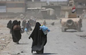 Displaced Iraqi civilians are escorted out of Mosul's Old City by Iraqi security forces