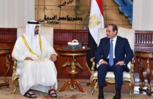 Egyptian President Abdel Fattah al-Sisi speaks with Abu Dhabi Crown Prince Sheikh Mohammed bin Zayed al-Nahyan after he arrives with delegation members in Cairo
