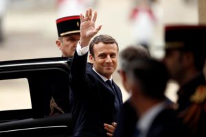 French President-elect Emmanuel Macron waves as he arrives to attend a handover ceremony with outgoing President Francois Hollande at the Elysee Palace in Paris
