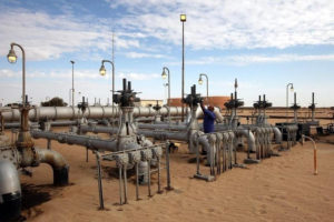 A worker checks pipes and valves at Amaal oil field in eastern Libya October 7