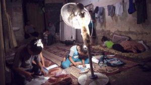 Kids write their homework in Gaza Strip amid power outage