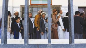 Yemenis line up to receive food aid in Sanaa, Yemen