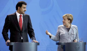 German Chancellor Angela Merkel, right, and Qatar's Emir Sheikh Tamim Bin Hamad Al Thani, left, address the media during a joint news conference as part of a meeting at the chancellery in Berlin, Germany, Friday, Sept. 15, 2017.