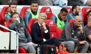 Arséne Wenger and the Arsenal bench feel the strain at Anfield.