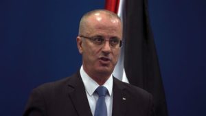 Palestinian Prime Minister Rami Hamdallah (R) speaks during a joint press conference at the Palestinian Authority headquarters in the West Bank city of Ramallah on April 25, 2017.