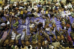 Migrants believed to be Rohingya rest inside a shelter after being rescued from boats at Lhoksukon in Indonesia's Aceh Province