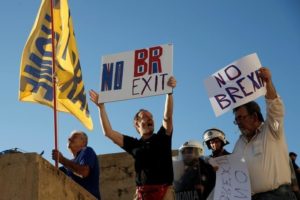 Anti-government demonstrators hold placards reading "No Brexit" during a protest outside the parliament in Athens