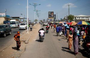 People walk along a street in Juba