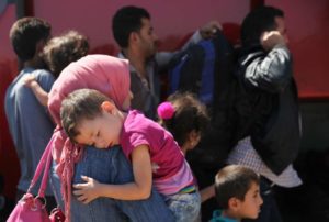 A woman holds her child outside the Kokkinotrimithia refugee camp outside Nicosia
