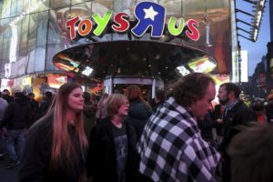 People walk past Toys R Us in Times Square the day after Christmas in the Manhattan borough of New York