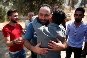 Prominent Palestinian activist Issa Amro is welcomed by supporters after being released on bail by a Palestinian court in the West Bank city of Hebron on September 10, 2017