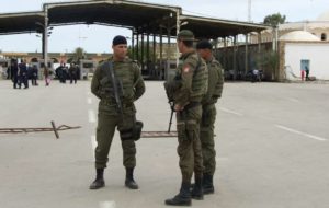 Tunisian security forces stand near the Ras Ajdir crossing on the country's border with Libya, close to Ben Guerdane