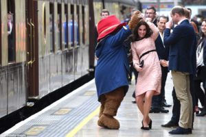 Kate Middleton dancing with the giant bear at Paddington station before a crowd of impressed onlookers.
