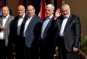 Palestinian Hamas Chief Ismail Haniyeh waves as he and senior Hamas leaders wait for the arrival of Egyptian intelligence chief Khaled Fawzi in Gaza City