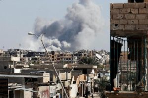 Smoke rises near the stadium where the Islamic State militants are holed up after an air strike by coalition forces at the frontline, in Raqqa, on Oct 12, 2017