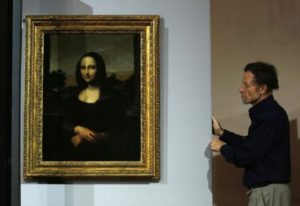 Mona Lisa Foundation's Vice President David Feldman moves Leonardo da Vinci's "Earlier Mona Lisa" painting into its viewing enclosure ahead of its exhibition in Singapore