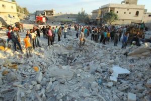 Residents inspect a site damaged by an airstrike in Hafsarja