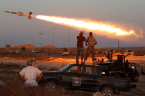 Fighters of Libyan forces allied with the UN-backed Government of National Accord (GNA) fire a rocket at ISIS militants in Sirte, Libya.